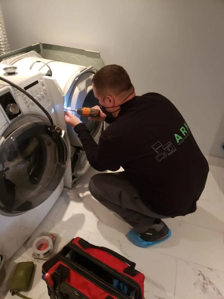 Repair technician is fixing appliance